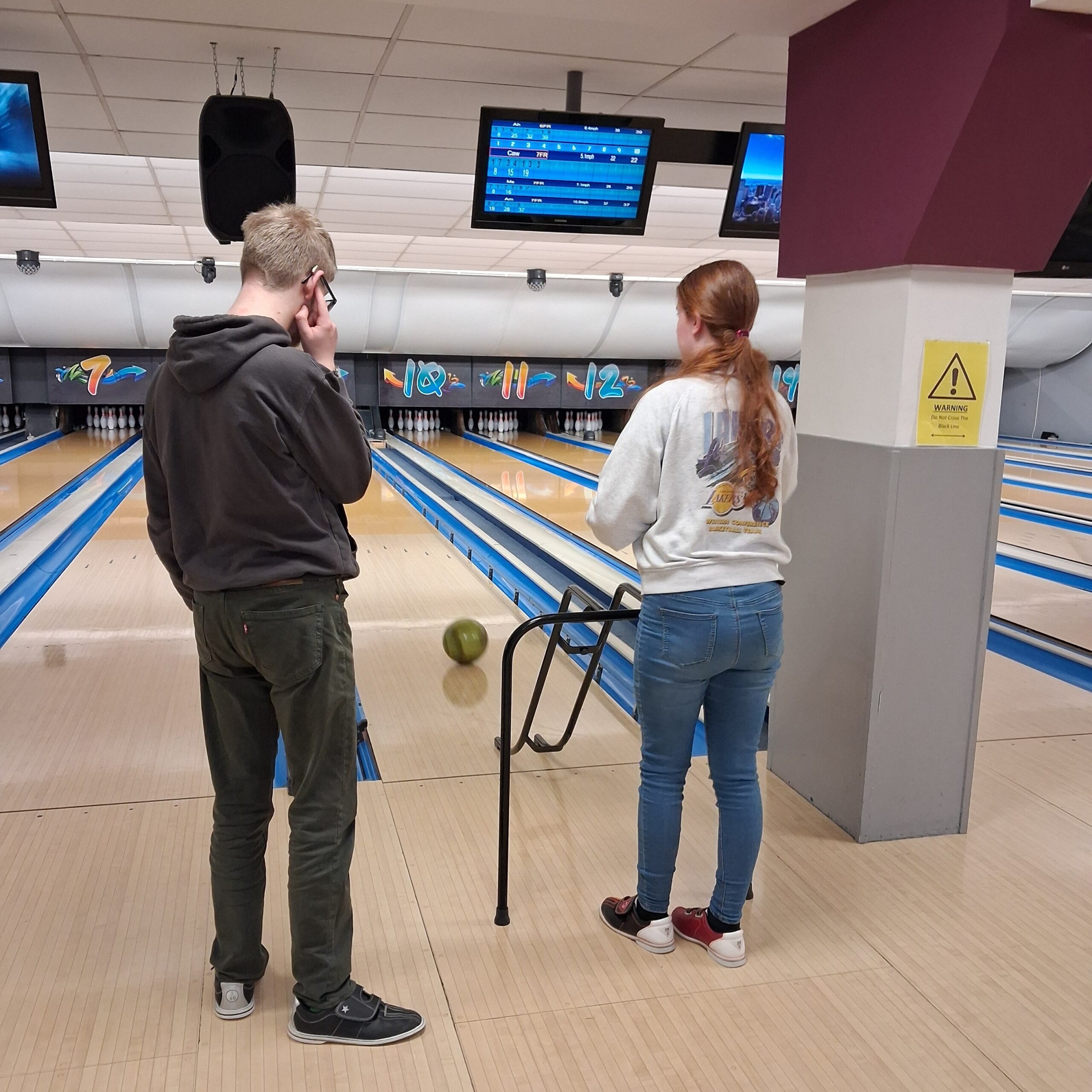 Young people taking part in a bowling activity together