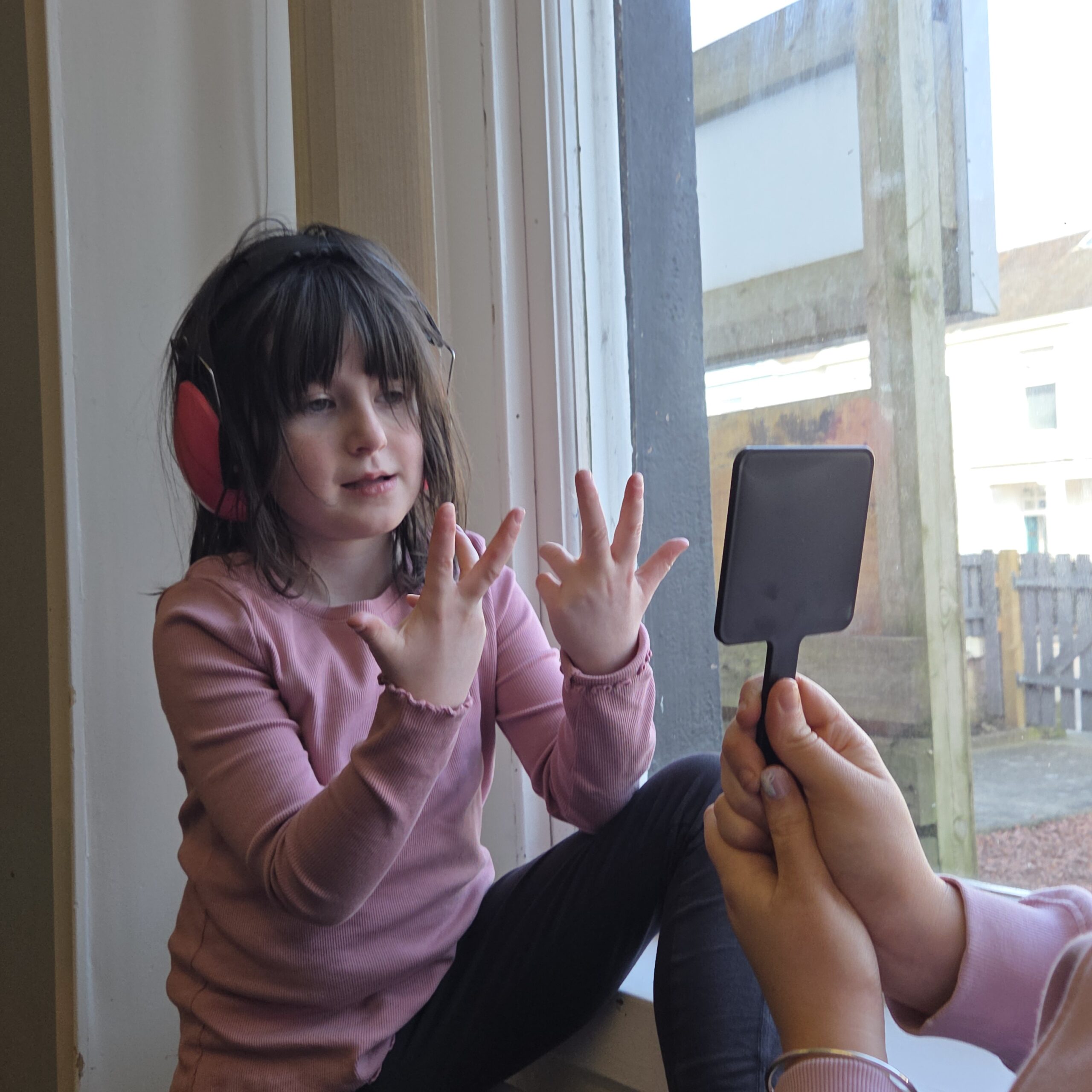 Child engaging in communication and emotional expression activities with support