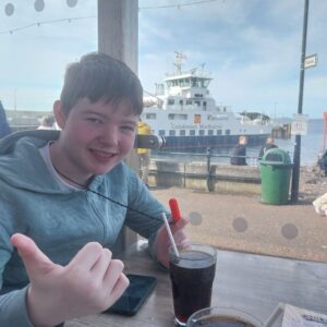 Young person enjoying a ferry during a community outing