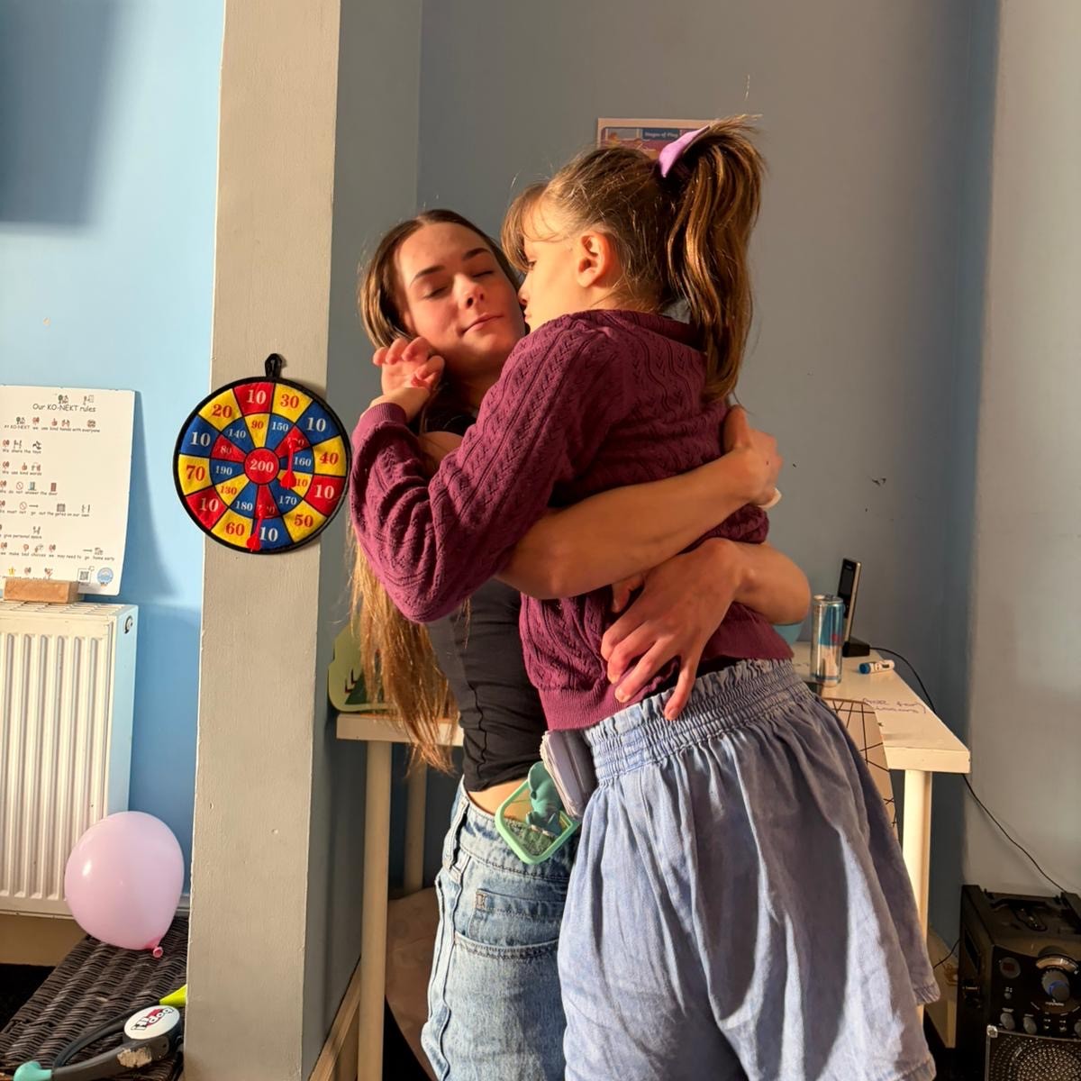 Support worker comforting a young person during a nurturing support session