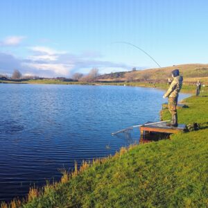 Young person taking part in an outdoor fishing and wellbeing activity