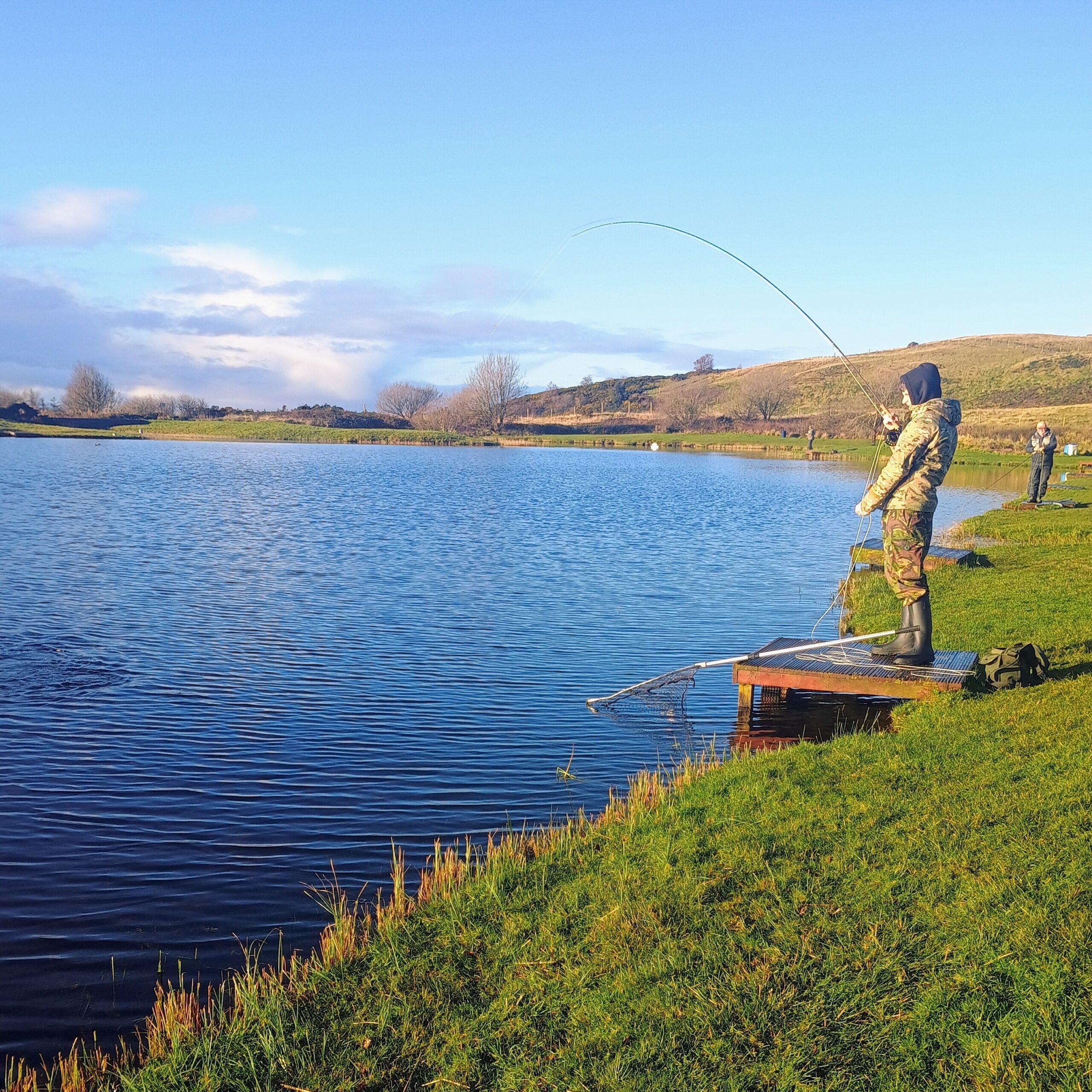 Young person taking part in an outdoor fishing and wellbeing activity
