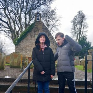 Young people exploring a historical outdoor location during a community activity